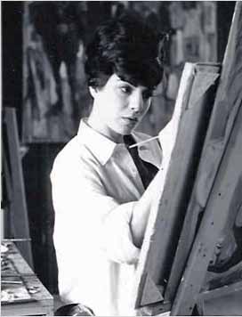 A young man is painting in an art studio. A young man is painting in an art studio.