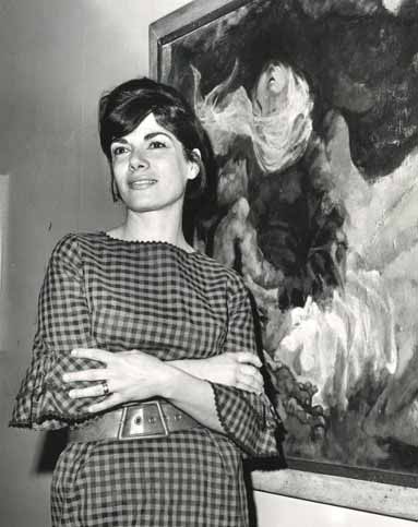 A woman standing in front of an art work. A woman standing in front of an art work.