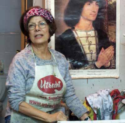 A woman standing in front of a painting. A woman standing in front of a painting.