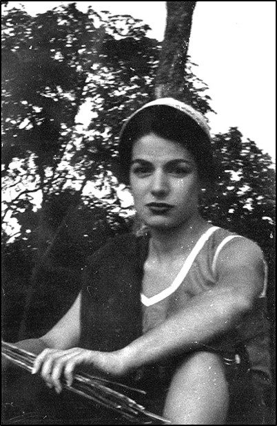 A woman in a white top and headband. A woman in a white top and headband.