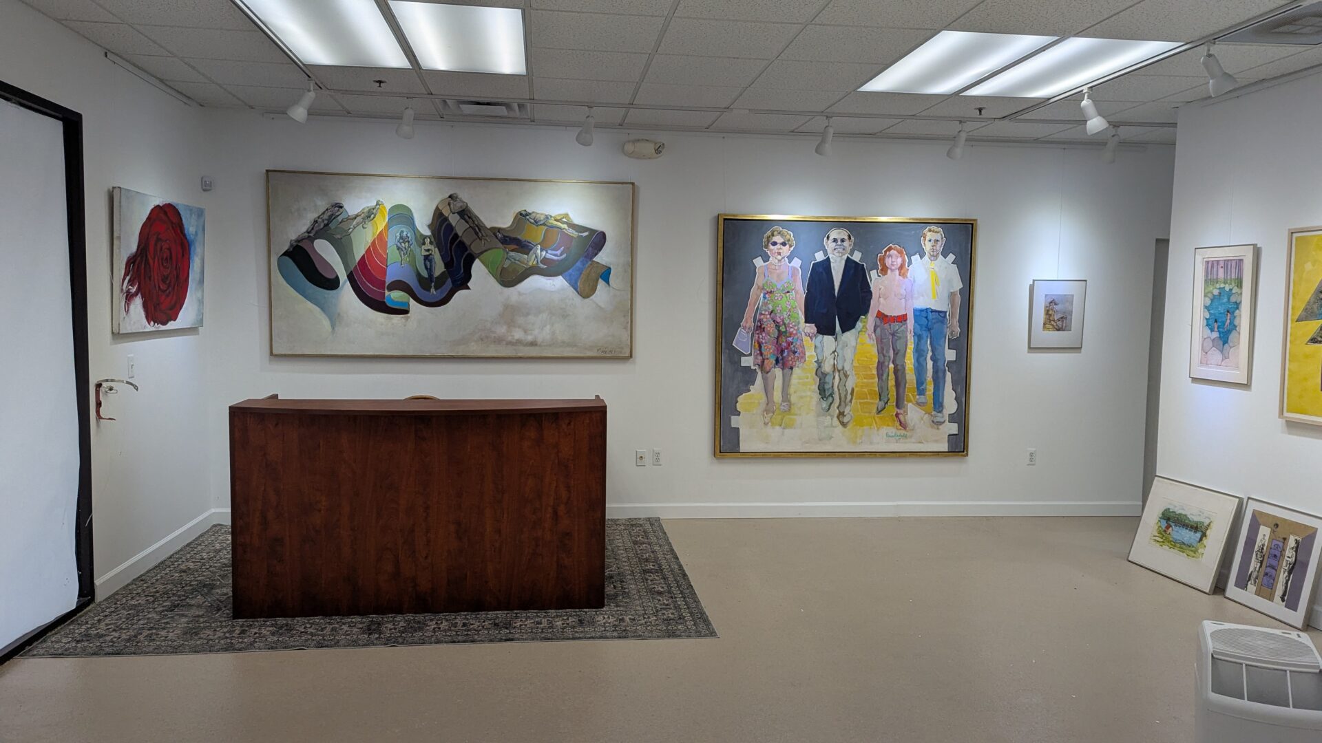 Two colorful abstract paintings displayed on a white gallery wall.